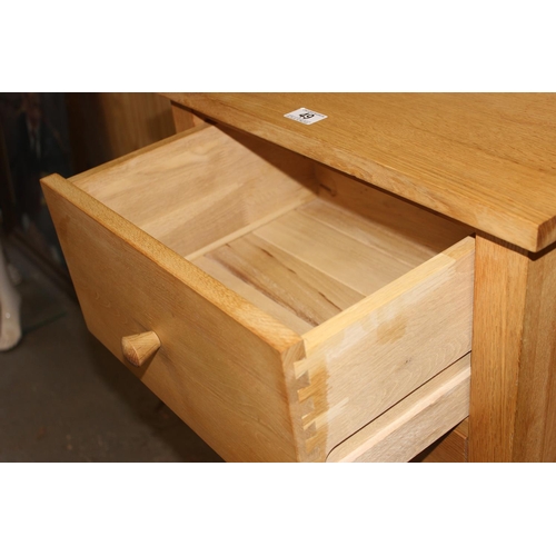 49 - A tall 5 drawer light oak finished chest of drawers