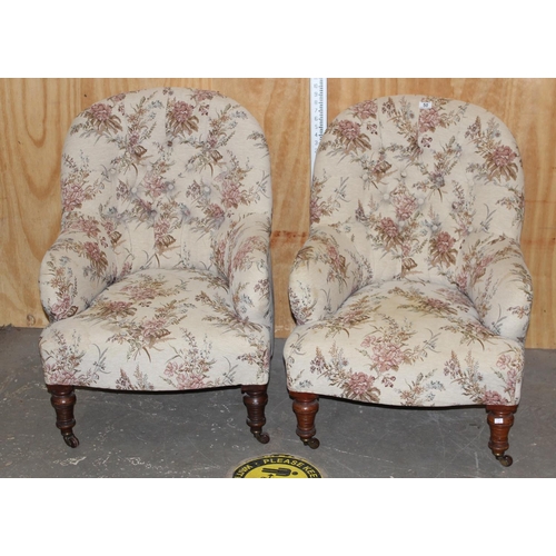 50 - Antique pair of button back chairs with floral fabric and standing on brass castors