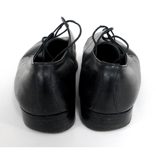 A pair of black leather shoes worn by Roger Moore, retailed by Simpson ...