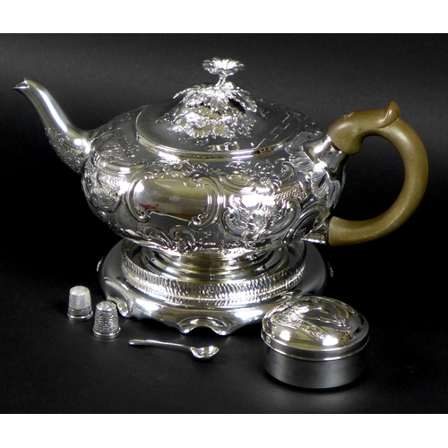 36 - A George III silver teapot, decorated in Rococo style with repousse foliate and floral scrolls, Rich... 