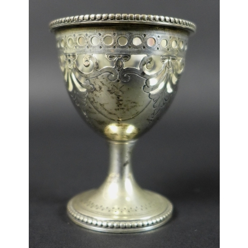 29 - A Victorian silver egg cup stand with six egg cups, raised scroll form handle, all with pierced and ... 