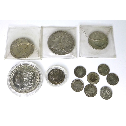 42 - A group of silver coins comprising an 1886 silver Morgan dollar, an 1896 silver Morgan dollar, a 193... 