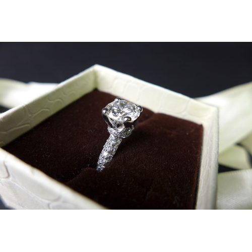 310 - A large and impressive platinum and diamond solitaire ring, the brilliant cut diamond approximately ... 