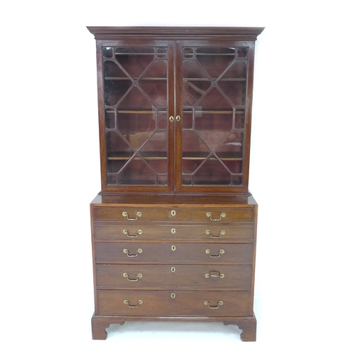 385 - A George III mahogany secretaire bookcase, the upper section with outswept cornice over two astragal... 