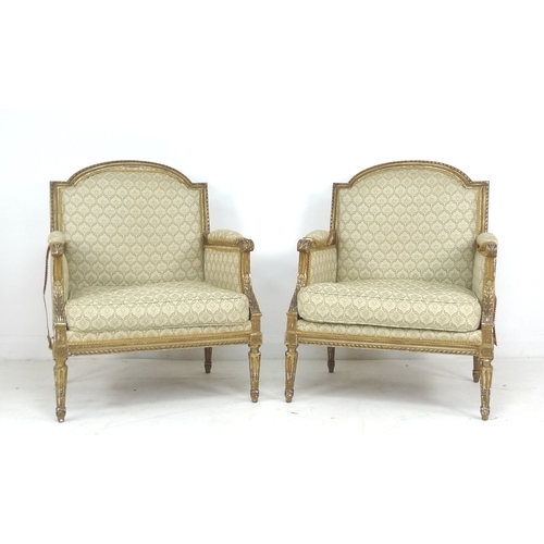 289 - A pair of late 19th century French giltwood armchairs, with carved gilt frames, upholstered in cream... 
