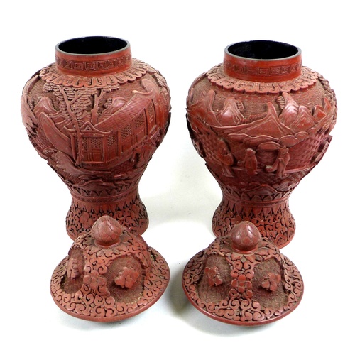 21 - A pair of Chinese covered vases, likely red resin, early to mid 20th century, made to resemble cinna... 