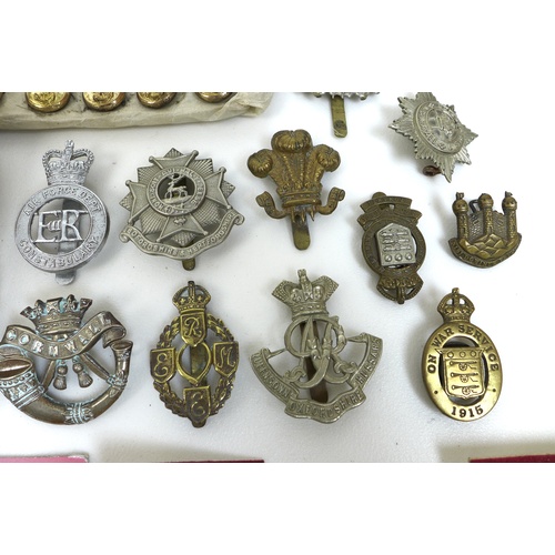 98 - Over one hundred and fifty British army badges and Royal Navy buttons, with approximately forty cap ... 