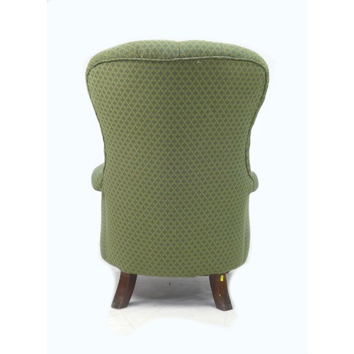 191 - A mid 20th century wing back armchair, with tapered legs, upholstered in green diamond patterned fab... 