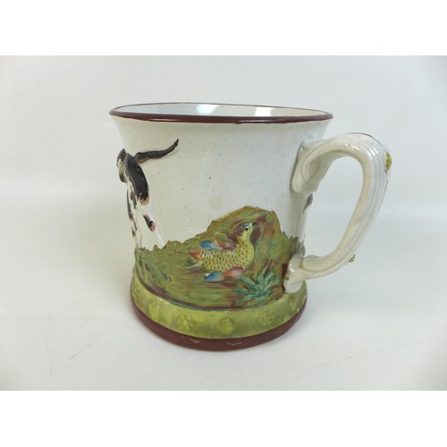 43 - An early 19th century Derby porcelain tankard, decorated with a reserve of trees by a flowing river ... 