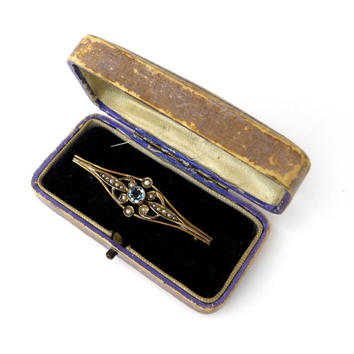 323 - An Edwardian 9ct gold, aquamarine, and seed pearl bar brooch, the central brilliant cut stone, 4.5 b... 