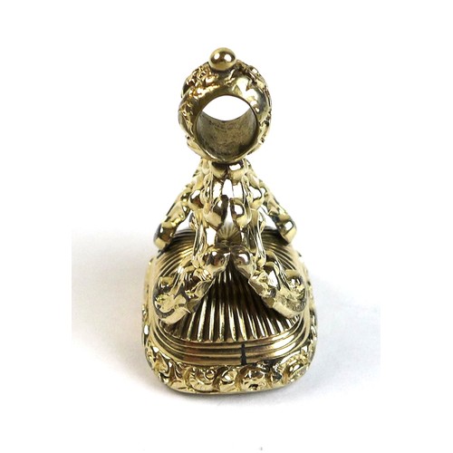 214 - A Victorian gold plated fob seal, the rococo scroll mount set with an intaglio carved smoked quartz,... 
