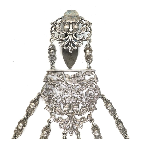 1 - A Edwardian silver plated chatelaine, the belt buckle featuring Green Man decoration, fitted with si... 