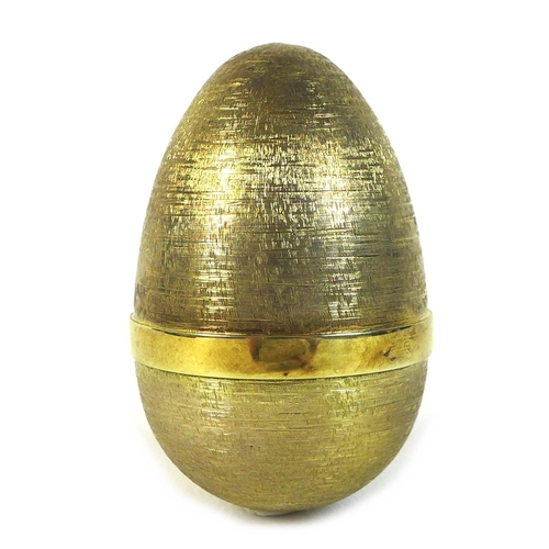 136 - A Stuart Devlin silver gilt 'Surprise' egg, the outer chased surface with plain band to middle, open... 