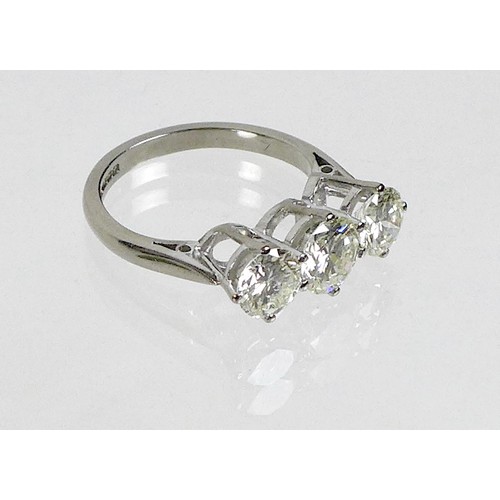 254 - An 18ct white gold and diamond three stone ring, the high claw set central brilliant cut stone, 6.7 ... 