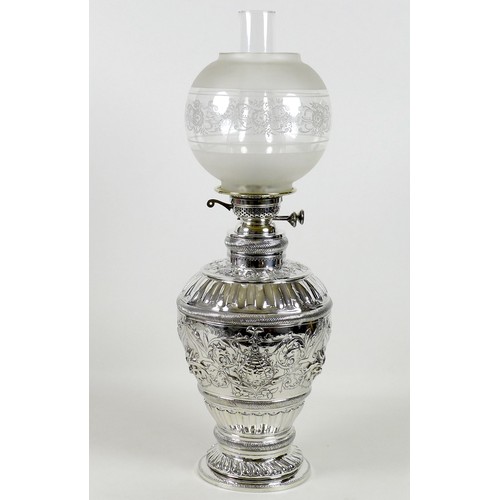 51 - A large and impressive 19th century silver paraffin lamp, of ovoid form with all over repousse decor... 