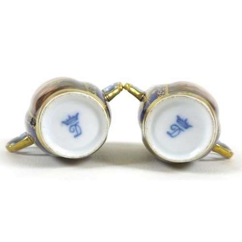 28 - A pair of Dresden porcelain cabinet twin handled cups and quatrefoil saucers, late 19th century, dec... 