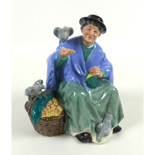 29 - A group of three Royal Doulton china figurines, comprising 'The Mask Seller', HN2103, 21.5cm high, '... 