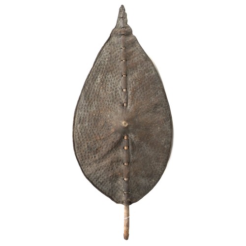 A Sudanese tribal shield, possibly Dinka, with animal hide cover, 53 by 9 by 117cm high.