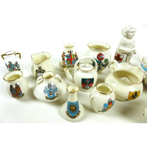 47 - A mixed group of collectables, including a quantity of W.H Goss crested china pieces, a travelling v... 