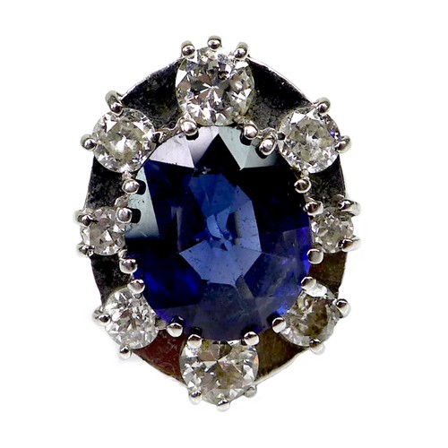 304 - A sapphire and diamond dress ring, the oval geometric cut royal blue sapphire of approximately 12 by... 