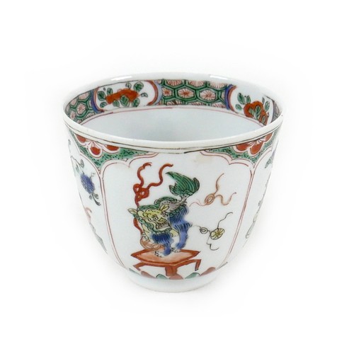 8 - A Chinese porcelain tea bowl, Kangxi mark and period, decorated in famille verte palette with four p... 