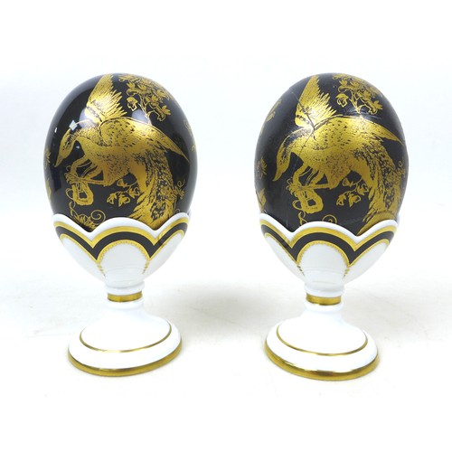 46 - Two Royal Crown Derby Faberge eggs, in 'Black Aves', both in original boxes and egg cups, with gold ... 