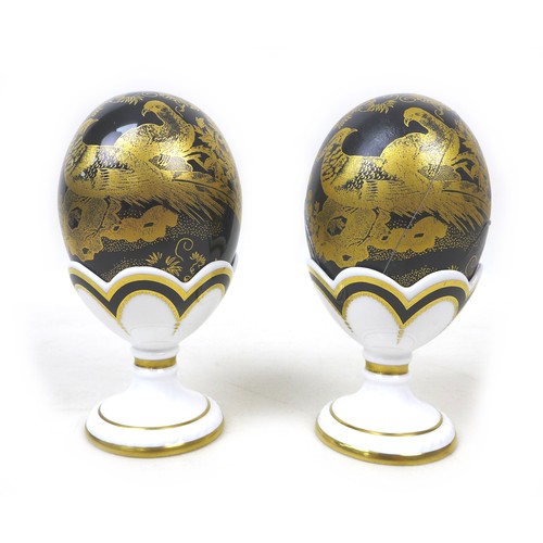 46 - Two Royal Crown Derby Faberge eggs, in 'Black Aves', both in original boxes and egg cups, with gold ... 