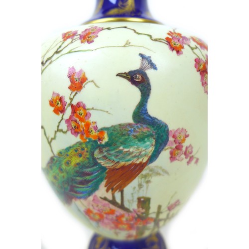 59 - A Royal Worcester vase and cover, painted with a peacock perched on a branch in a blossom tree, on c... 