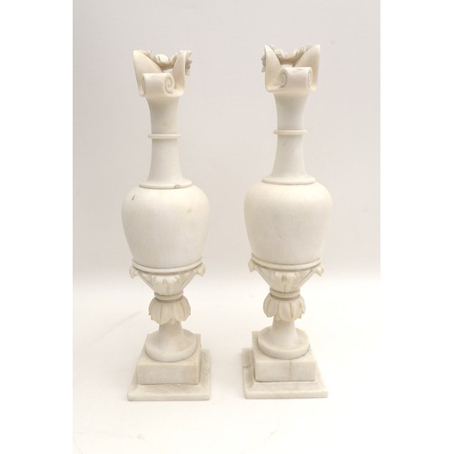 30 - A pair of 19th century alabaster urns, the spouts carved as a birds beaks, with moulded flower and l... 