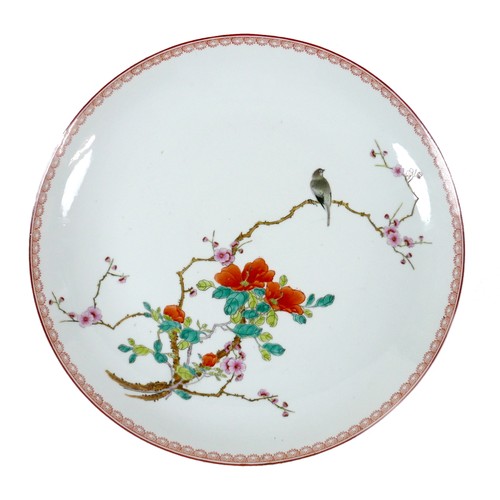 2 - A Chinese porcelain dish, mid 20th century, decorated in enamels with a bird on a blossoming branch,... 