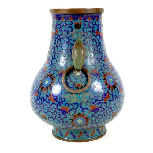 6 - A Chinese cloisonné enamel twin handled vase, Qing Dynasty, mid to late 19th century, of Hu form, de... 
