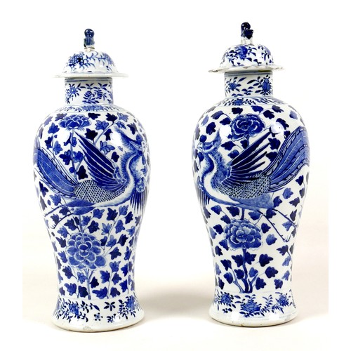 11 - A pair of Chinese porcelain vases, Qing Dynasty, 19th century, each of baluster form, the associated... 