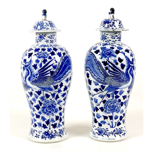 11 - A pair of Chinese porcelain vases, Qing Dynasty, 19th century, each of baluster form, the associated... 