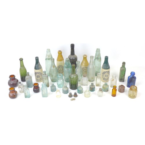 13 - An assortment of vintage glass and stoneware bottles, including Trealaw Rhonda Valley Aerated Water ... 