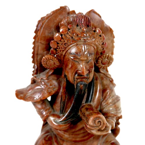 11A - A Chinese soapstone carving, early 20th century, modelled as a warrior holding a scroll, 27cm high.