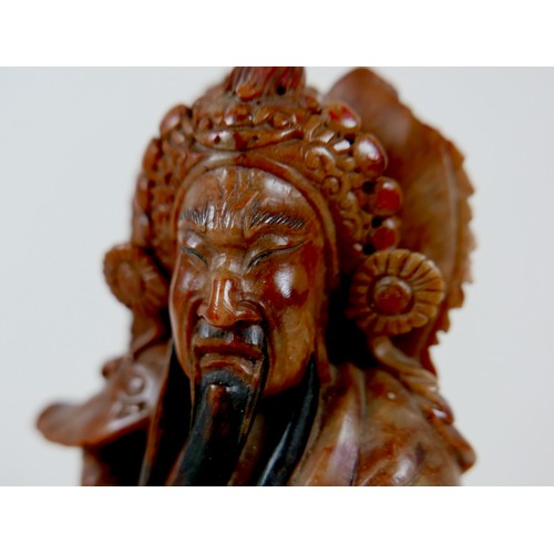 11A - A Chinese soapstone carving, early 20th century, modelled as a warrior holding a scroll, 27cm high.