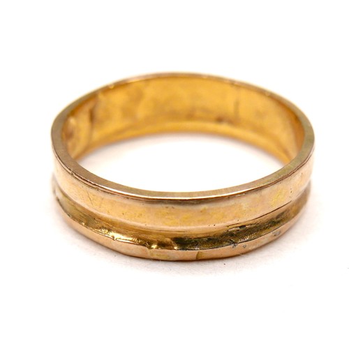 A gold wedding band ring, formed from two separate thinner rings joined