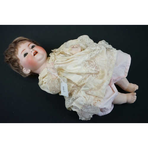 179 - Simon & Halbig bisque headed doll with brown glass flirty eyes, teeth, good face & hair, some cracki... 