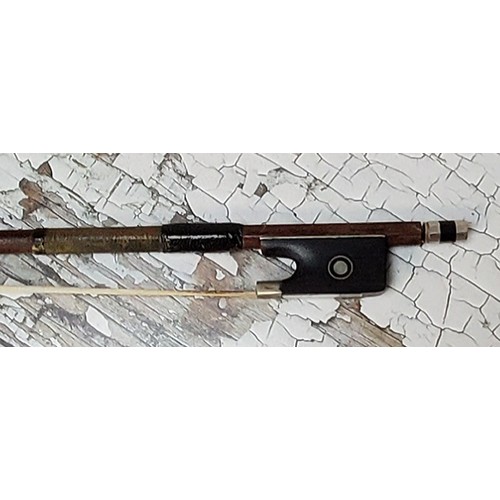 35 - A German silver mounted violin bow, stamped GERMANY, ebony frog inlaid with mother of pearl eyes and... 