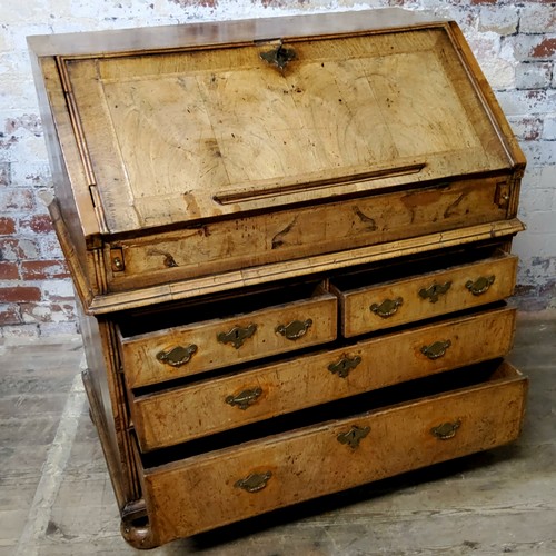 138 - A period Queen Anne burr walnut feather banded bureau, the sloping fall enclosing an arrangement of ... 