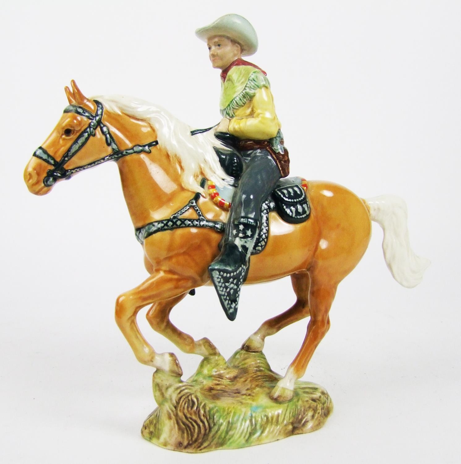 A Beswick pottery cowboy on horseback, number 1377, height 23cm (9in.).