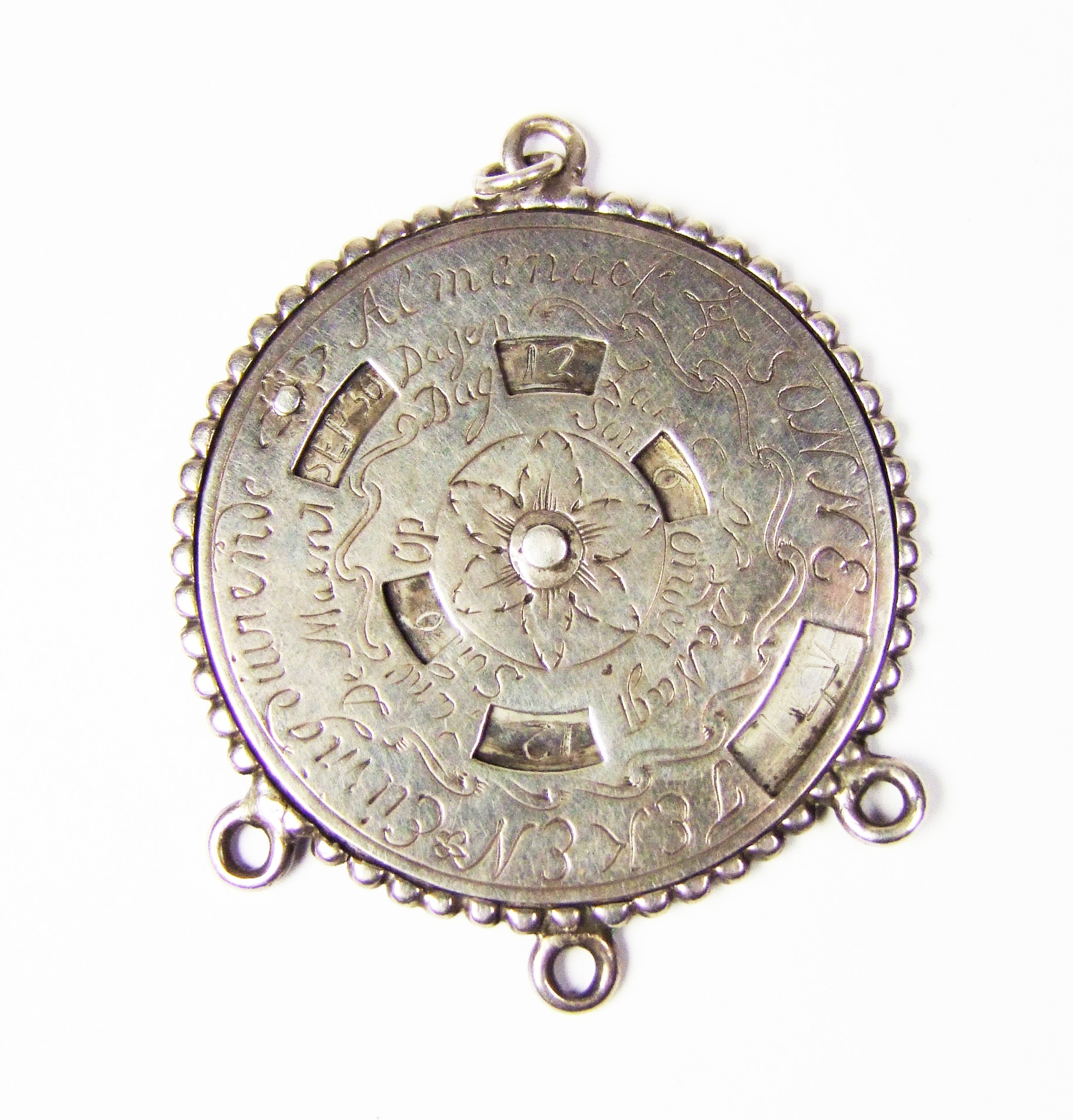 A Dutch silver perpetual calendar, c. 1700, of circular form, the dial