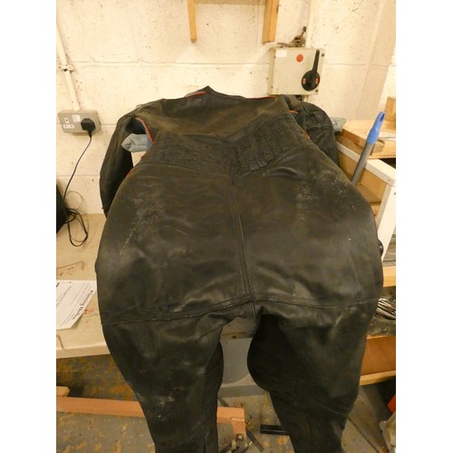 24 - A leather one piece racing suit, fitted a 5 foot 10 inch male