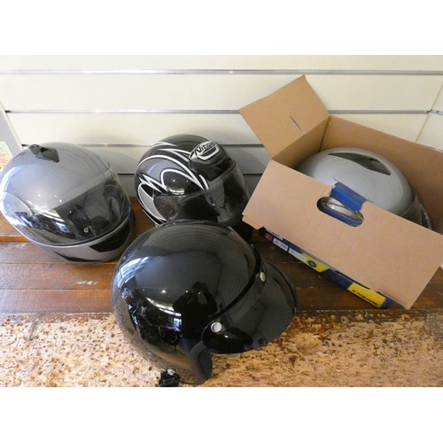 23 - Four motorcycle helmets, for display purposes only.