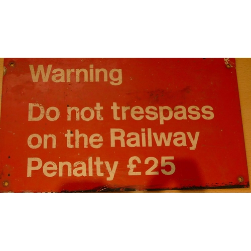 252 - An orange and white metal sign 'Warning do not trespass on the railway penalty £25' 20 x 30 cm