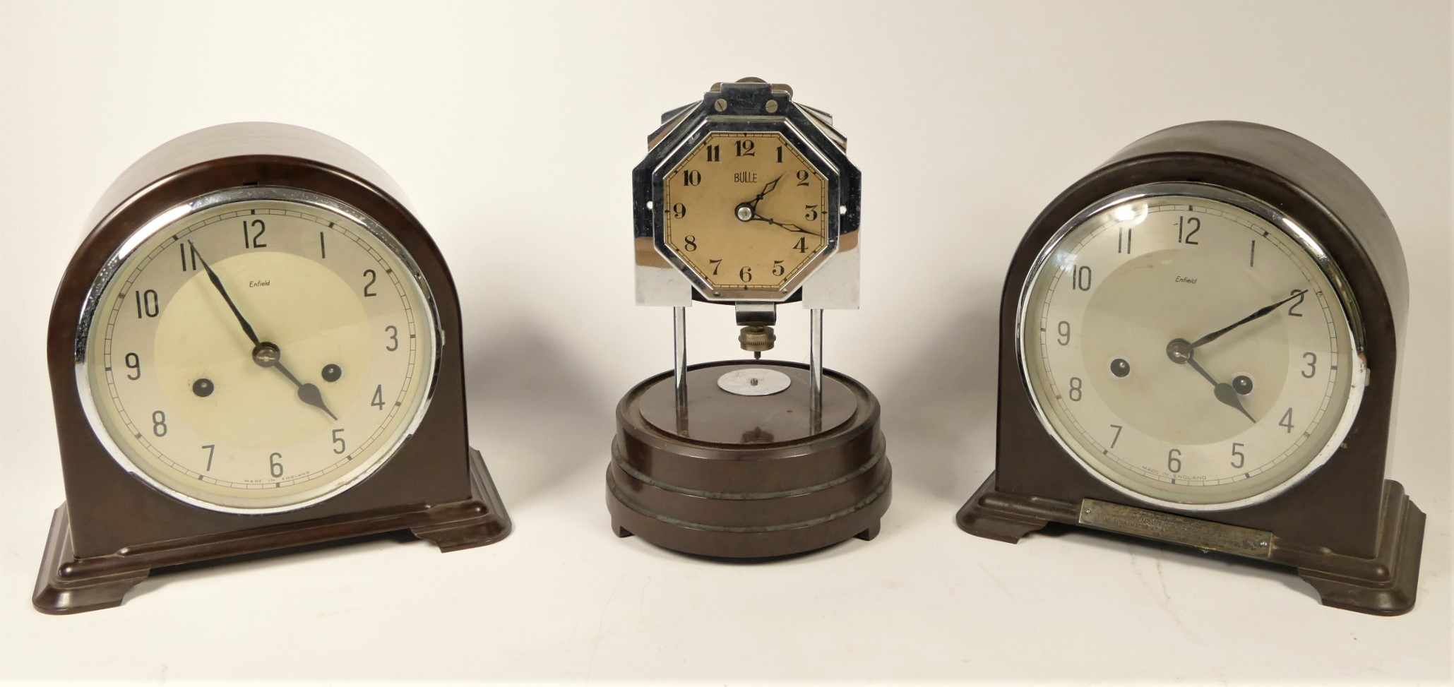 A Bulle manual wind mantel clock together with two Bakelite Enfield mantel clocks, and a selection o