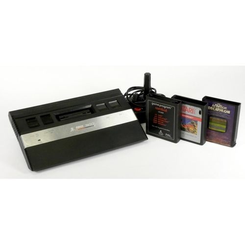 3 - An Atari 2600 (serial No AT 860202696), AV and power cables, Atari joystick and three cartridges to ... 
