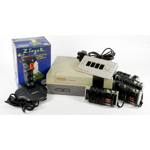 51 - A Nintendo NES (model No NESE-001), AV and power cables, a Nintendo Four Score adapter, four NES con... 