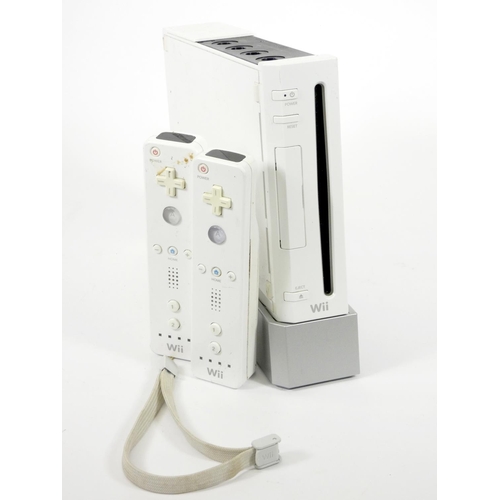 70 - A Nintendo Wii Console, with two Wii remotes, light bar, stand, AV and power cables, manual, togethe... 
