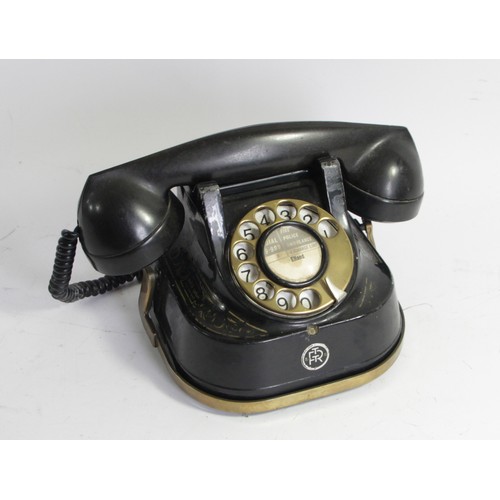 96 - An RTT Telephone, with brass carry handle, painted metal casing and Bakelite receiver, c1950s, paper... 